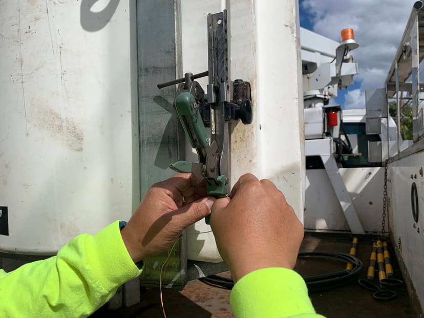 Telecom technician performing aerial splice work