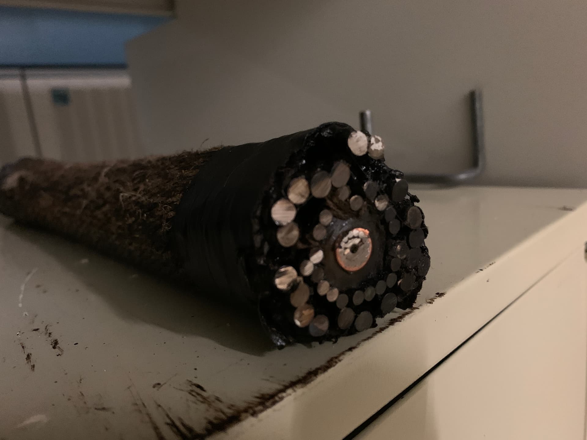 Side view of submarine fiber cable cross-section showing armor wires and internal structure
