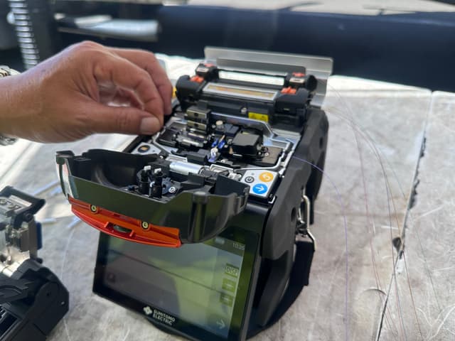 Sumitomo fusion splicer being loaded with fiber